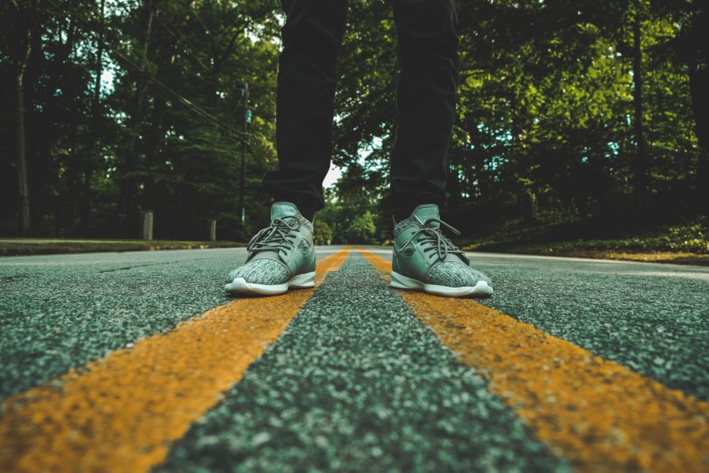 person standing on concrete road